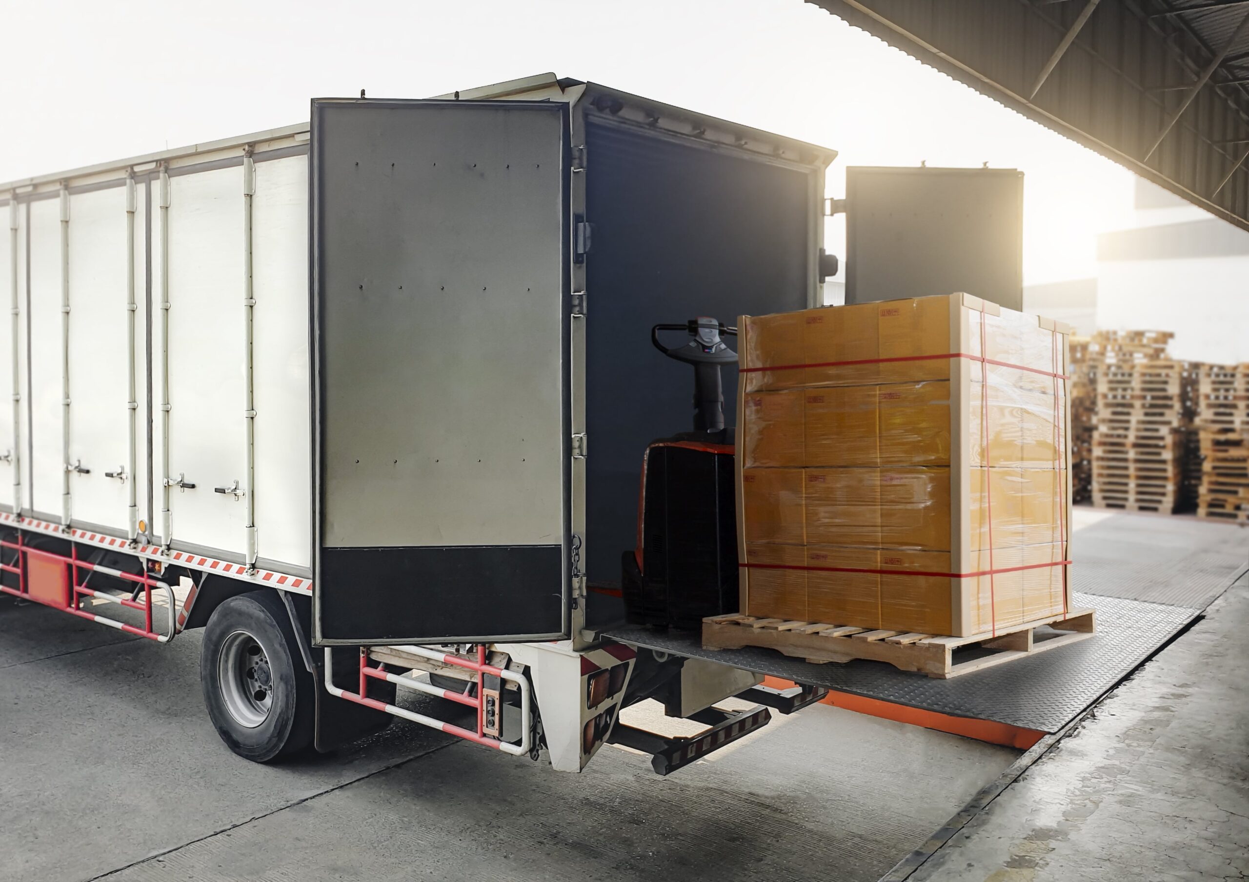 package boxes loading into shipping cargo container warrehouse shipping logistics freight trucks min scaled